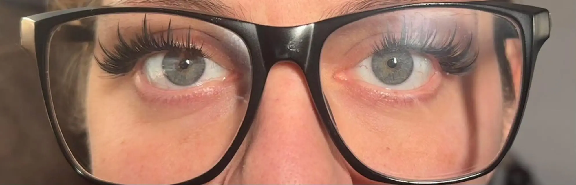 Cluster lash set shown through glasses for everyday wear