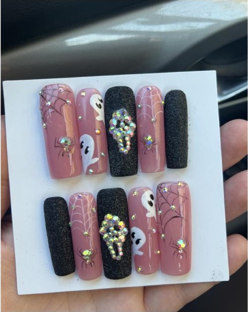 Halloween-themed press-on nail set with ghosts, spiders, and gems